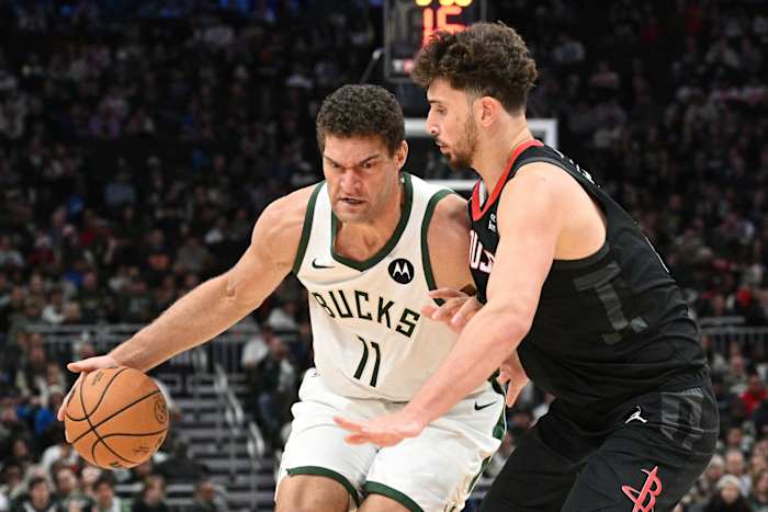 Milwaukee Bucks center Brook Lopez (11) drives against Houston Rockets center Alperen Sengun (28)